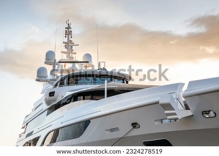 Close up detail of a modern charter or private superyacht, with a dramatic sky in the background Royalty-Free Stock Photo #2324278519