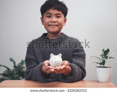 A boy holding piggy bank. Learning financial responsibility and projecting savings. savings concept. investment concept.