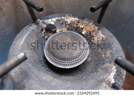 Close-up photo of gas stove base.