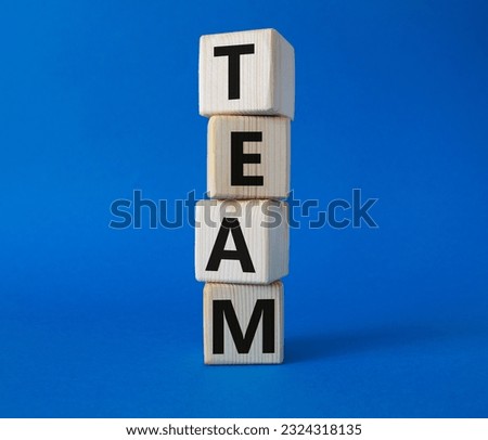 Team symbol. Concept word Team on wooden cubes. Beautiful blue background. Business and Team concept. Copy space.