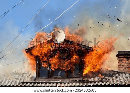 fire on the roof of a wooden house Royalty-Free Stock Photo #2324332683