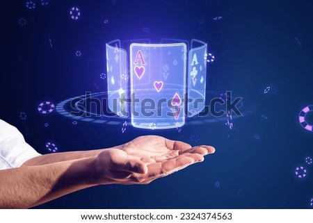 Close up of businessman hands holding creative digital blue cards hologram on dark background. Online casino, poker and digital gaming concept