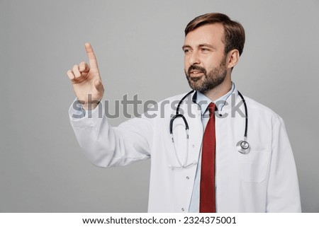 Full body male doctor man wears white medical gown suit work in hospital hold index finger pov click on screen workspace isolated on plain grey background studio portrait. Healthcare medicine concept