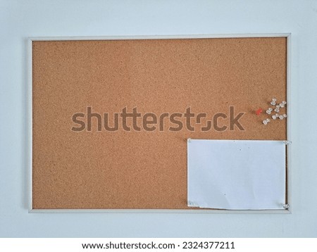 White frame cork board with pins
