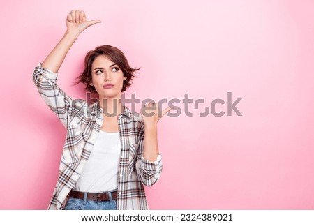 Photo of suspicious looking businesswoman doubts pointing fingers empty space uncertain about warranty isolated on pink color background