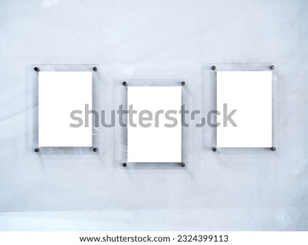 Three mockups of white blank paper poster or photo frames, acrylic materials, vertical style hanging on white dirty wall background. Royalty-Free Stock Photo #2324399113