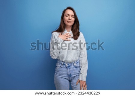 pretty young brunette woman in shirt keep calm on studio background