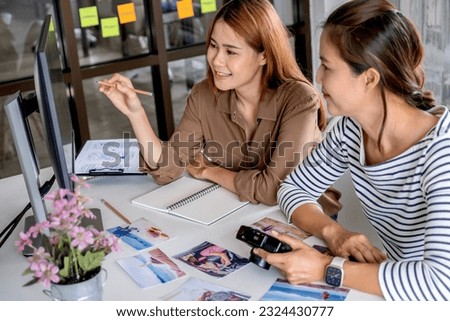 Photographer and graphic designer working in office creating team discussing ideas in advertising agency. 