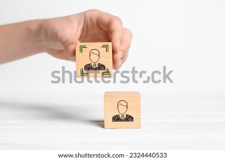 Professional buyer. Woman holding wooden cube with human icon on white background, closeup