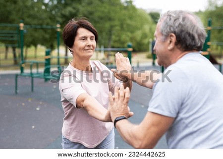 Friendly family couple doing gymnastic exercises together