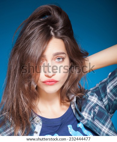 young beautiful girl posing grimacing with chewing gum