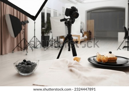 Professional equipment and composition with delicious dessert on wooden table in studio. Food photography