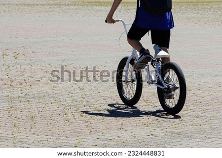 A young teenage cyclist riding bicycles around the city.