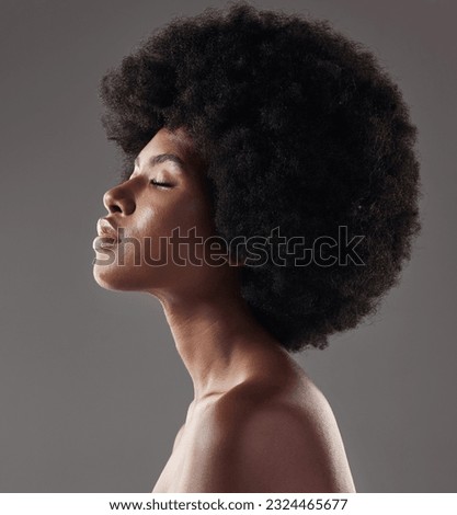 Natural haircare, profile and black woman with afro hairstyle, beauty and skincare on grey background. Hair care, cosmetics and beautiful face of African model with skin glow and shine in studio. Royalty-Free Stock Photo #2324465677