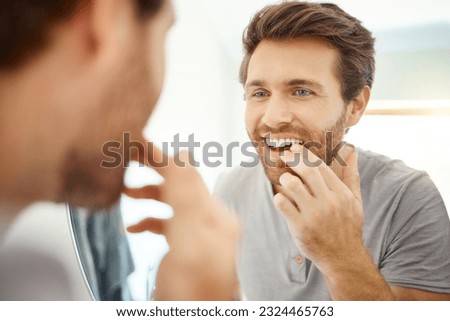 Teeth, morning routine and mirror with man in bathroom for self care, oral hygiene and dental. Cleaning, smile and health with face of male person at home for beauty, wellness and reflection Royalty-Free Stock Photo #2324465763
