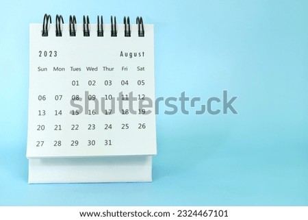 Selective focus of August 2023 desk calendar on blue background with copy space. Royalty-Free Stock Photo #2324467101