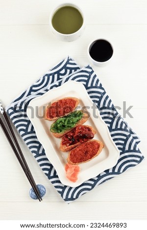 Inarisuzhi, Sushi Pocket with Various Topping. Japanese Food ob White Table  Royalty-Free Stock Photo #2324469893
