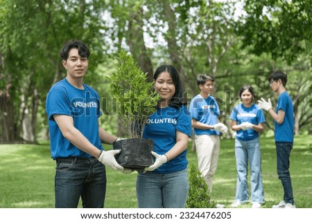 Portrait, flowers and young volunteering in park for community, outreach or program together. Environment, charity and friends volunteer in forest for gardening project, happy and smile in nature Royalty-Free Stock Photo #2324476205