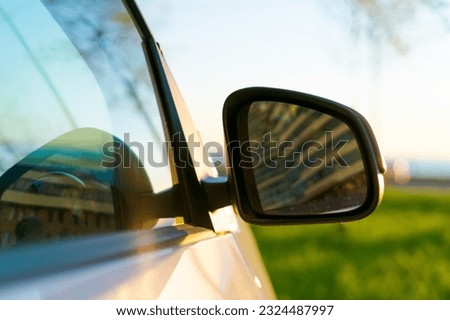 car side mirror on nature and sunset background, travel concept