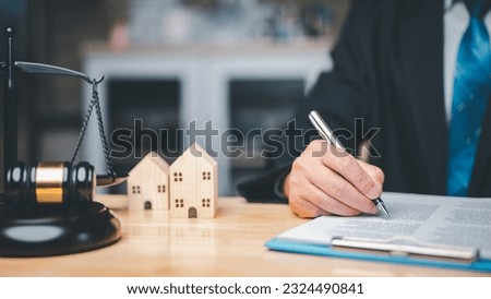 In a divorce business concept, the judge's gavel, law book placed on desk in courtroom represent gravity and seriousness of situation as couples resolve conflicts, reach agreements through legal means Royalty-Free Stock Photo #2324490841