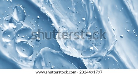 Collagen And Hyaluron Serum Gel On Skin. Splashing of Hyaluron gel. Liquid hyaluronic acid gel on skin. Cosmetic bubbles Gel texture on skin black background. Textured background. skin care product Royalty-Free Stock Photo #2324491797
