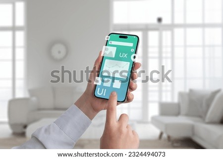 User interface concept. Smart phone in hands with flying app design elements Royalty-Free Stock Photo #2324494073