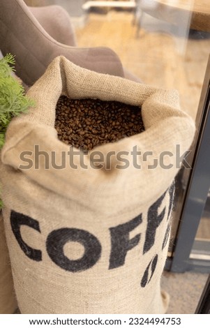Canvas large bag of coffee beans. A piece of furniture in a cafe Vertical photo