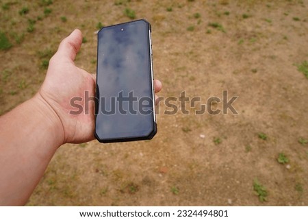 A black screen smartphone is being held