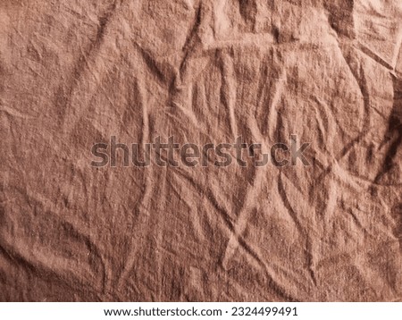 Abstract background and texture of crumpled brown fabric. Texture, pattern, frame and copy space