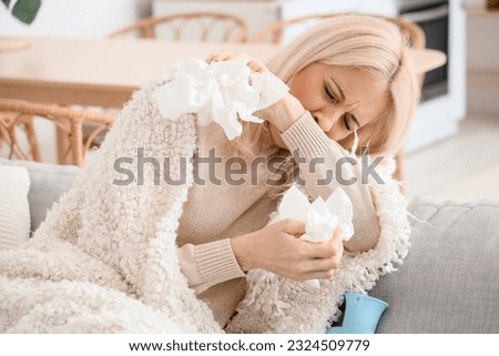 Ill mature woman with tissues at home, closeup Royalty-Free Stock Photo #2324509779