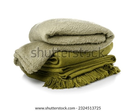 Different soft folded blankets on white background Royalty-Free Stock Photo #2324513725