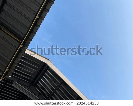Corrugated Steel Warehouse Wall of Industrial Building against blue clear sky Background .
