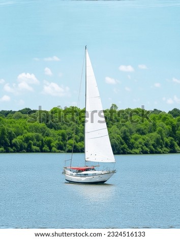 sailing boat on river by village