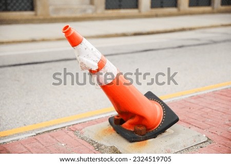 bright orange construction cones arranged in a line, symbolizing safety, caution, and ongoing progress in construction and infrastructure projects. The cones represent temporary barriers
