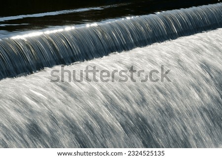 Beautiful flowing water over a cascading bridge forming stunning patterns and textures.showing the stunning movement of nature and the calm energy that exists. perfect for meditation and meditating 
