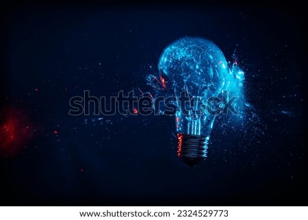 broken bulb with impact on black background, high-speed photography Royalty-Free Stock Photo #2324529773