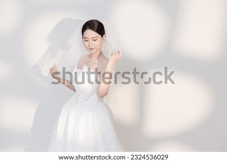 Asian girl's white wedding dress Royalty-Free Stock Photo #2324536029