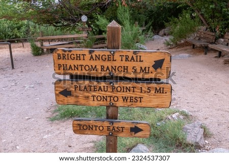 Wooden directional sign of Bright Angel hiking trail and Plateau Point at South Rim of Grand Canyon National Park, Arizona, USA. Beginning of trailhead in the wilderness of North America. Wanderlust