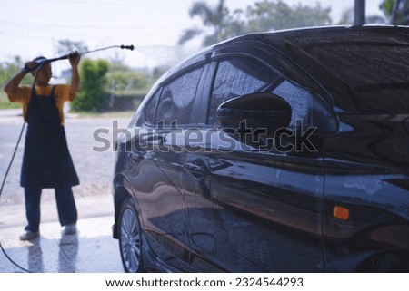 Car washing cleaning car using high pressure water background