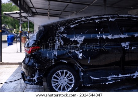 Car washing cleaning car using high pressure water background