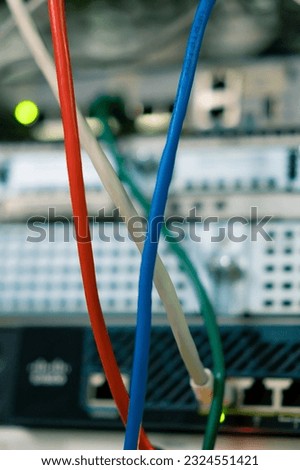 a bunch of patch network cables sorted in a rack cabinet leading from a patch panel in a server rack in data center room internet cloud storage