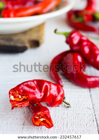 the broken chili peppers on a white background, spices