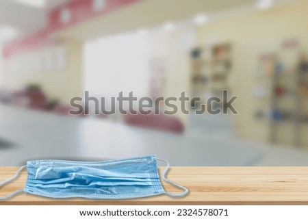 Medical face mask on school table, surgical drape in the classroom,  pupils in class, children