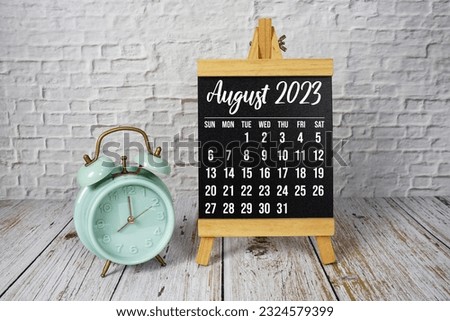 August 2023 monthly calendar on easel stand on wooden background Royalty-Free Stock Photo #2324579399