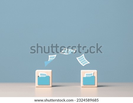Data copy, move, synchronize. Transfer files between folders, Backup data, Exchange files, send pictures, music, or doc to your partner. Wooden blocks with virtual document loading to another folder. Royalty-Free Stock Photo #2324589685