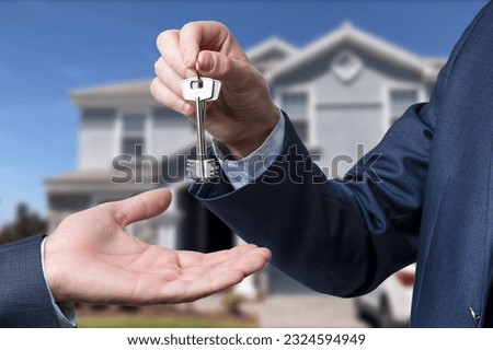 The real estate agent gives the keys to the meeting after the signing of the lease