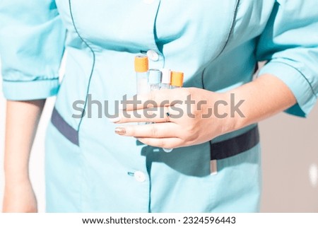 Doctor  holding test tubes . Portrait of doctor on white background, medical photo. Tubes for analysis