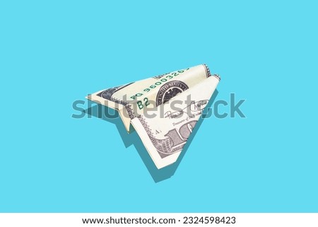 Travel flight money and money growth concept. US dollar airplane on blue minimal background. Income, budget, spending and business idea.