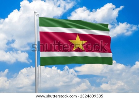 Suriname national flag waving in the wind on clouds sky. High quality fabric. International relations concept