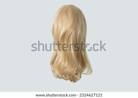 Blonde wig. Elongated caret. White background, isolate. Back view. Royalty-Free Stock Photo #2324627121